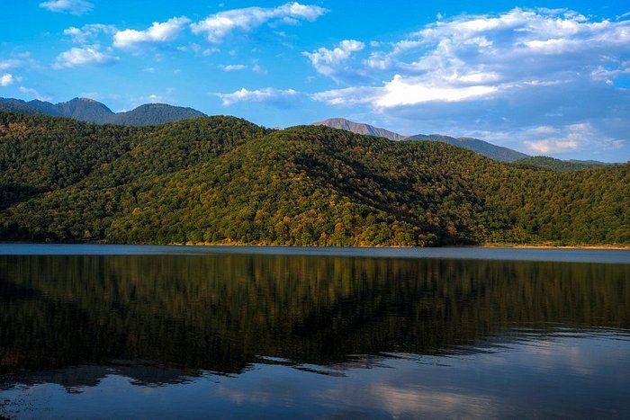 Nohur Lake in 7 days Azerbaijan, a serene oasis nestled amidst lush greenery and mountains, reflecting the tranquility of nature.